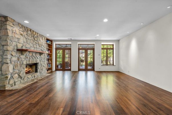 Empty room, Fireplace, Interior, Recessed Lighting, Stone Walls, Wood Texture Flooring