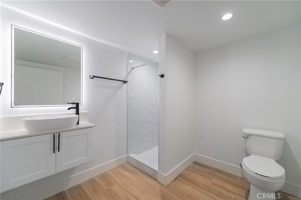 Bathroom, Glass Shower, Interior, Marble Walls, Recessed Lighting, Wood Texture Flooring