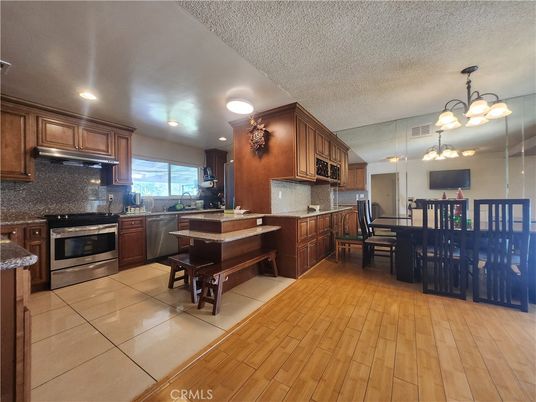 Chandelier, Dining room, Interior, Kitchen, Recessed Lighting, Stainless Steel Appliances, Wood Texture Flooring
