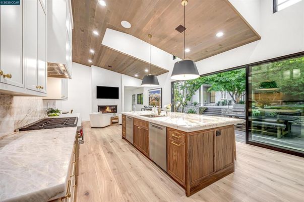 Fireplace, Interior, Kitchen, Living room, Pendant Lights, Recessed Lighting, Stainless Steel Appliances, Wooden Ceilings, Wood Texture Flooring