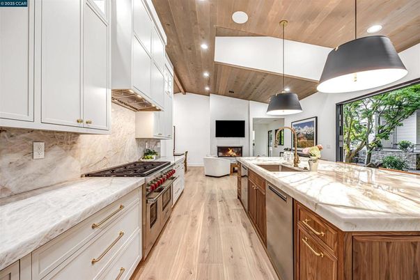 Fireplace, Interior, Kitchen, Living room, Pendant Lights, Recessed Lighting, Stainless Steel Appliances, Wooden Ceilings, Wood Texture Flooring