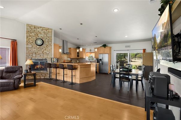 Dining room, Fireplace, Interior, Kitchen, Pendant Lights, Recessed Lighting, Stainless Steel Appliances, Stone Walls, Wood Texture Flooring