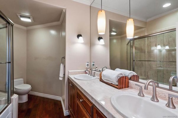 Bathroom, Dual Sink Vanities, Glass Shower, Interior, Pendant Lights, Recessed Lighting, Wood Texture Flooring