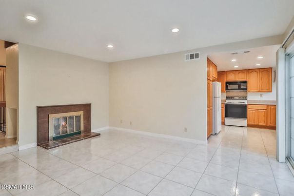 Empty room, Fireplace, Interior, Kitchen, Recessed Lighting, Stainless Steel Appliances