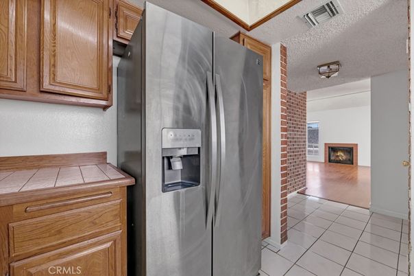 Fireplace, Interior, Kitchen, Stone Walls, Tile Countertops, Wood Texture Flooring