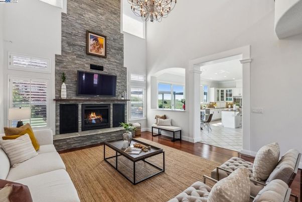 Chandelier, Fireplace, Interior, Living room, Recessed Lighting, Stone Walls, Wood Texture Flooring