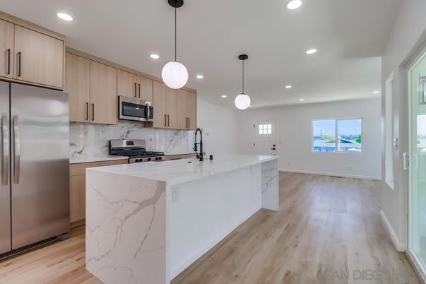 Interior, Kitchen, Marble Walls, Pendant Lights, Recessed Lighting, Stainless Steel Appliances, Wood Texture Flooring