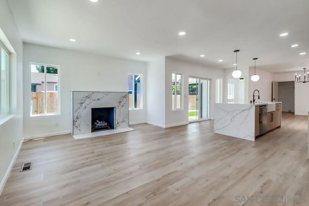 Empty room, Fireplace, Interior, Kitchen, Marble Walls, Pendant Lights, Recessed Lighting, Wood Texture Flooring