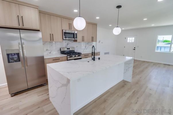 Interior, Kitchen, Marble Walls, Pendant Lights, Recessed Lighting, Stainless Steel Appliances, Wood Texture Flooring