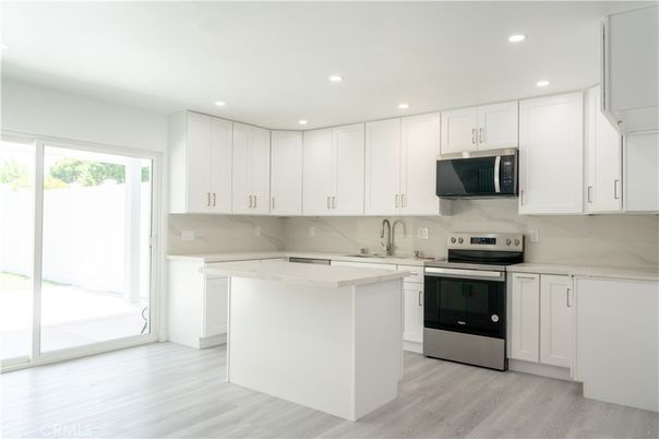 Interior, Kitchen, Marble Walls, Recessed Lighting, Stainless Steel Appliances, Wood Texture Flooring