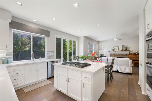 Dining room, Fireplace, Interior, Kitchen, Living room, Recessed Lighting, Stainless Steel Appliances, Wood Texture Flooring