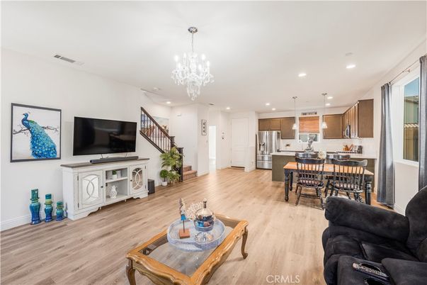 Chandelier, Dining room, Interior, Kitchen, Living room, Pendant Lights, Recessed Lighting, Stainless Steel Appliances, Wood Texture Flooring