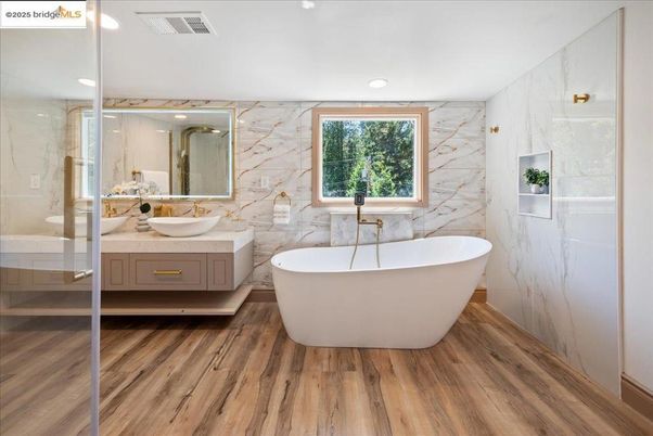 Bathroom, Dual Sink Vanities, Free Standing Baths, Glass Shower, Interior, Marble Walls, Recessed Lighting, Wood Texture Flooring