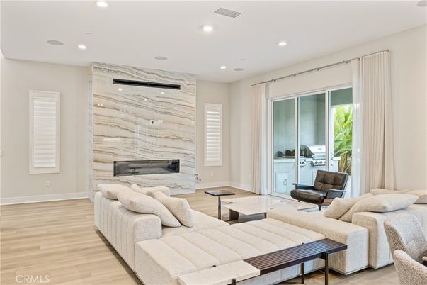 Fireplace, Interior, Living room, Marble Walls, Recessed Lighting, Wood Texture Flooring