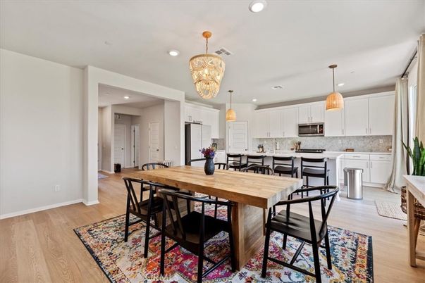 Chandelier, Dining room, Interior, Kitchen, Pendant Lights, Recessed Lighting, Stainless Steel Appliances, Wood Texture Flooring