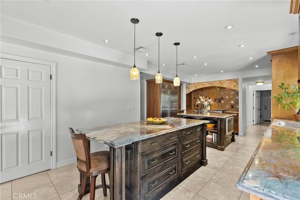 Fireplace, Interior, Kitchen, Pendant Lights, Recessed Lighting, Stainless Steel Appliances, Stone Walls