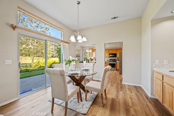 Chandelier, Dining room, Interior, Kitchen, Pendant Lights, Stainless Steel Appliances, Wood Texture Flooring