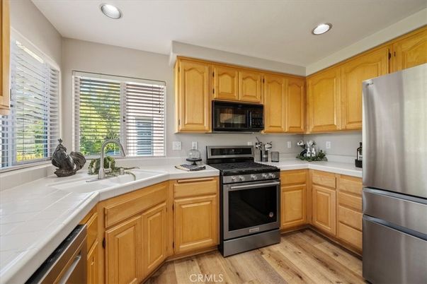 Interior, Kitchen, Recessed Lighting, Stainless Steel Appliances, Tile Countertops, Wood Texture Flooring