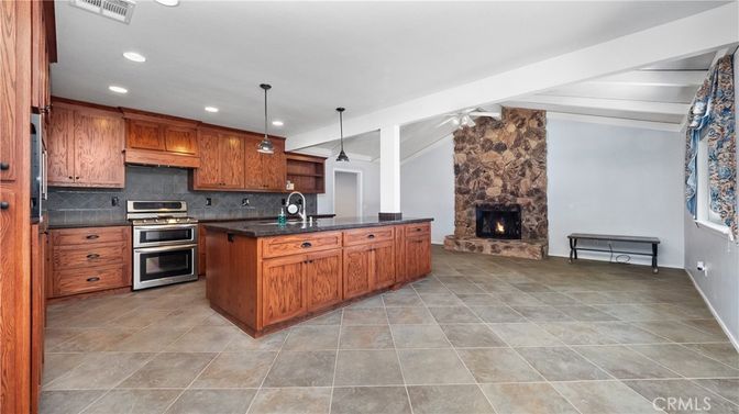 Fireplace, Interior, Kitchen, Pendant Lights, Recessed Lighting, Stainless Steel Appliances, Stone Walls