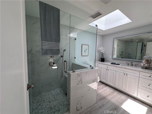Bathroom, Dual Sink Vanities, Glass Shower, Interior, Marble Walls, Wood Texture Flooring