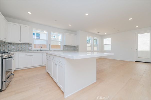 Interior, Kitchen, Recessed Lighting, Tile Countertops, Wood Texture Flooring