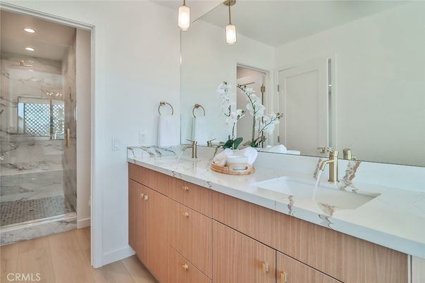 Bathroom, Dual Sink Vanities, Glass Shower, Interior, Marble Walls, Pendant Lights, Recessed Lighting, Wood Texture Flooring