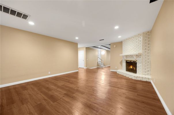 Empty room, Fireplace, Interior, Recessed Lighting, Stone Walls, Wood Texture Flooring