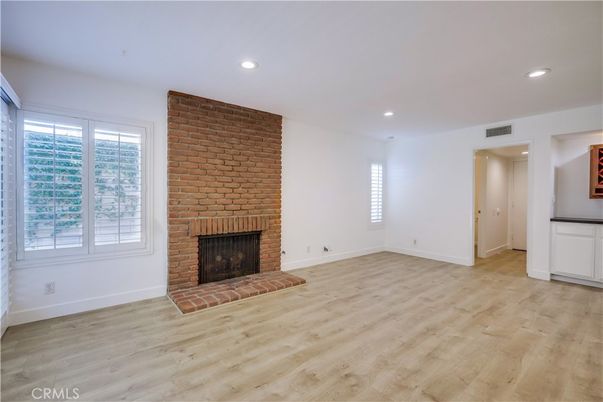 Empty room, Fireplace, Interior, Recessed Lighting, Stone Walls, Wood Texture Flooring
