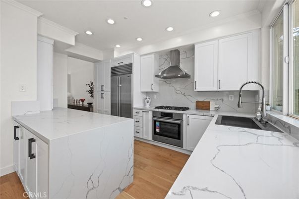 Interior, Kitchen, Marble Walls, Recessed Lighting, Stainless Steel Appliances, Wood Texture Flooring