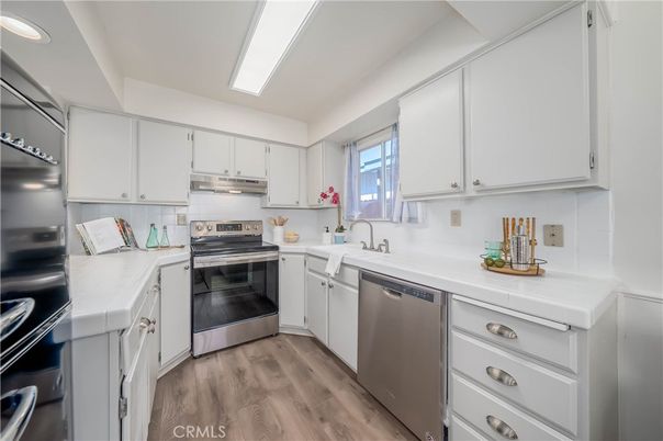 Interior, Kitchen, Recessed Lighting, Stainless Steel Appliances, Tile Countertops, Wood Texture Flooring
