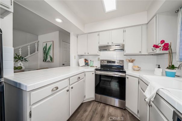 Interior, Kitchen, Recessed Lighting, Stainless Steel Appliances, Tile Countertops, Wood Texture Flooring