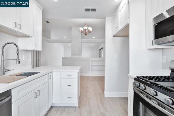 Chandelier, Interior, Kitchen, Recessed Lighting, Stainless Steel Appliances, Wood Texture Flooring