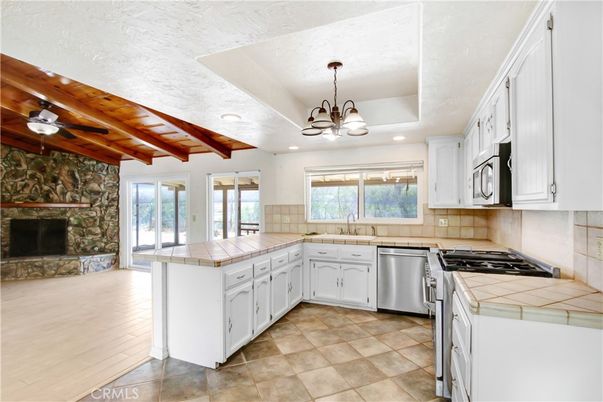 Fireplace, Interior, Kitchen, Recessed Lighting, Stainless Steel Appliances, Stone Walls, Tile Countertops, Wooden Beams, Wooden Ceilings