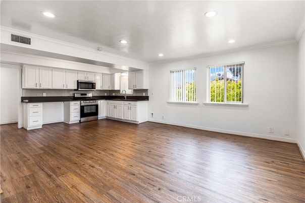 Empty room, Interior, Kitchen, Recessed Lighting, Stainless Steel Appliances, Wood Texture Flooring