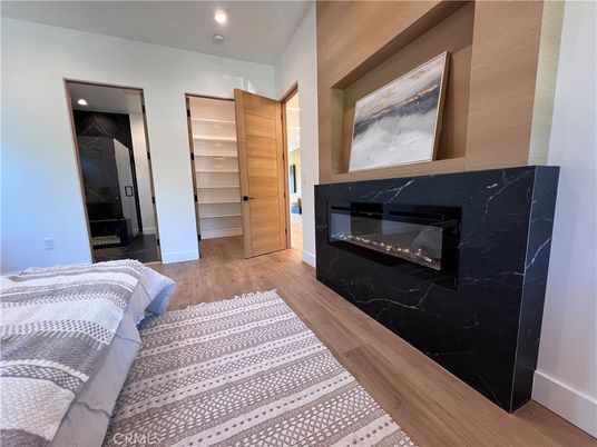 Bedroom, Fireplace, Interior, Marble Walls, Recessed Lighting, Wood Texture Flooring