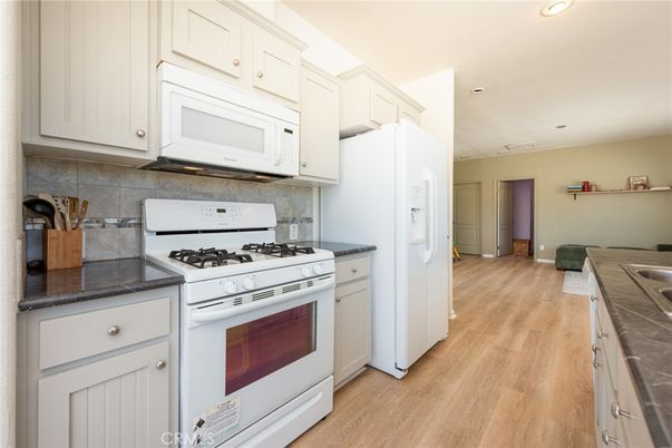 Interior, Kitchen, Recessed Lighting, Tile Countertops, Wood Texture Flooring