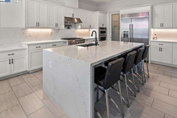 Interior, Kitchen, Marble Walls, Recessed Lighting, Stainless Steel Appliances, Wood Texture Flooring