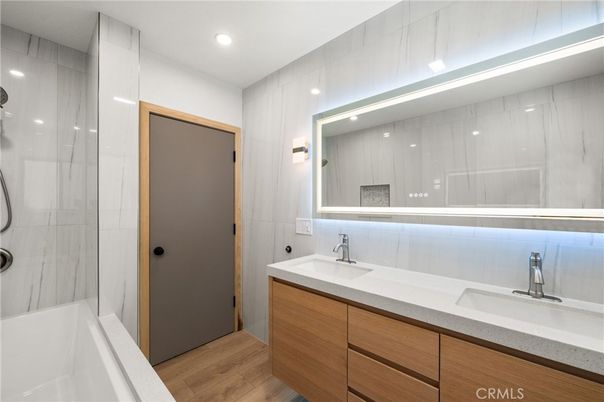Bathroom, Dual Sink Vanities, Glass Shower, Interior, Recessed Lighting, Wood Texture Flooring