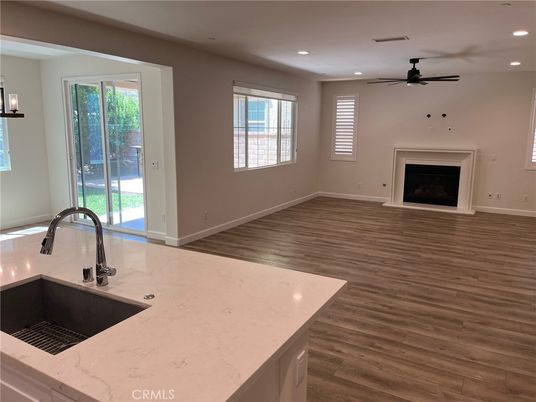 Empty room, Fireplace, Interior, Kitchen, Recessed Lighting, Wood Texture Flooring