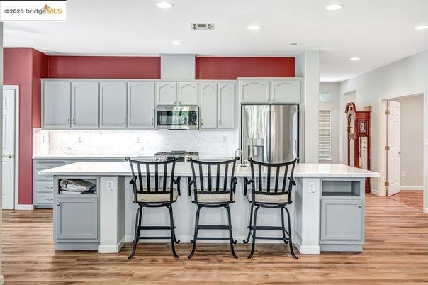 Interior, Kitchen, Marble Walls, Recessed Lighting, Stainless Steel Appliances, Wood Texture Flooring