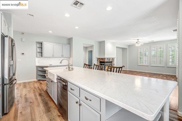 Dining room, Fireplace, Interior, Kitchen, Recessed Lighting, Stainless Steel Appliances, Wood Texture Flooring
