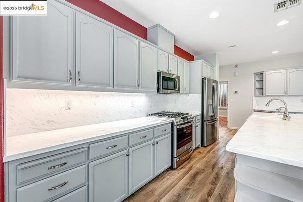 Interior, Kitchen, Marble Walls, Recessed Lighting, Stainless Steel Appliances, Wood Texture Flooring