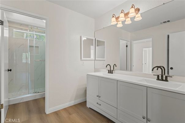 Bathroom, Dual Sink Vanities, Glass Shower, Interior, Marble Walls, Wood Texture Flooring