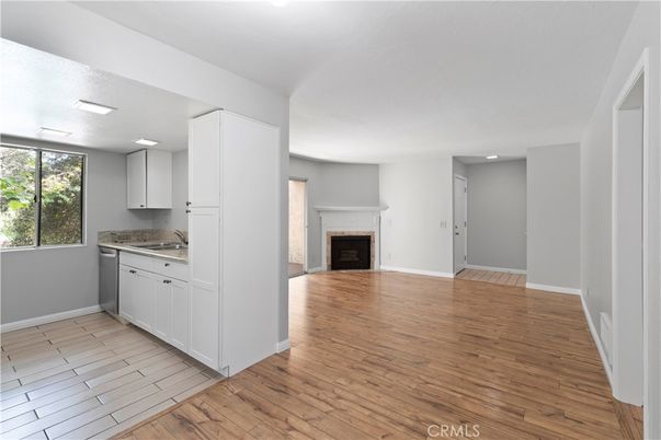 Empty room, Fireplace, Interior, Kitchen, Recessed Lighting, Wood Texture Flooring