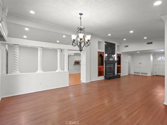 Chandelier, Empty room, Fireplace, Interior, Recessed Lighting, Wood Texture Flooring