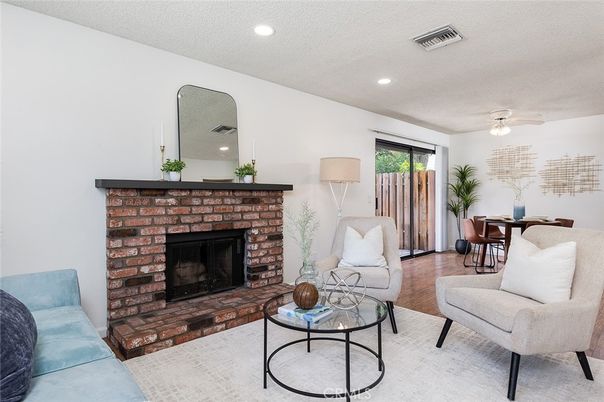 Dining room, Fireplace, Interior, Living room, Recessed Lighting, Wood Texture Flooring
