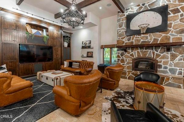 Chandelier, Fireplace, Interior, Living room, Recessed Lighting, Stone Walls, Wooden Beams