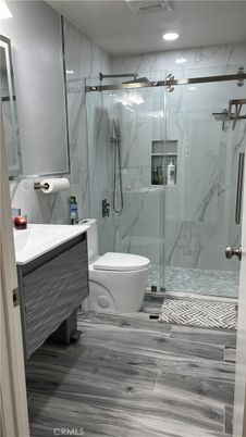 Bathroom, Glass Shower, Interior, Marble Walls, Recessed Lighting, Wood Texture Flooring