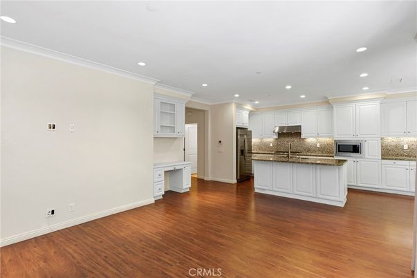Empty room, Interior, Kitchen, Recessed Lighting, Stainless Steel Appliances, Wood Texture Flooring