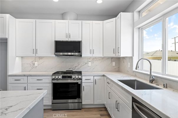 Interior, Kitchen, Marble Walls, Recessed Lighting, Stainless Steel Appliances, Wood Texture Flooring